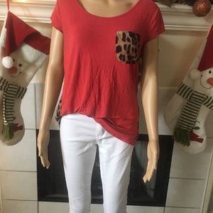 Red orange top with leopard print pocket.